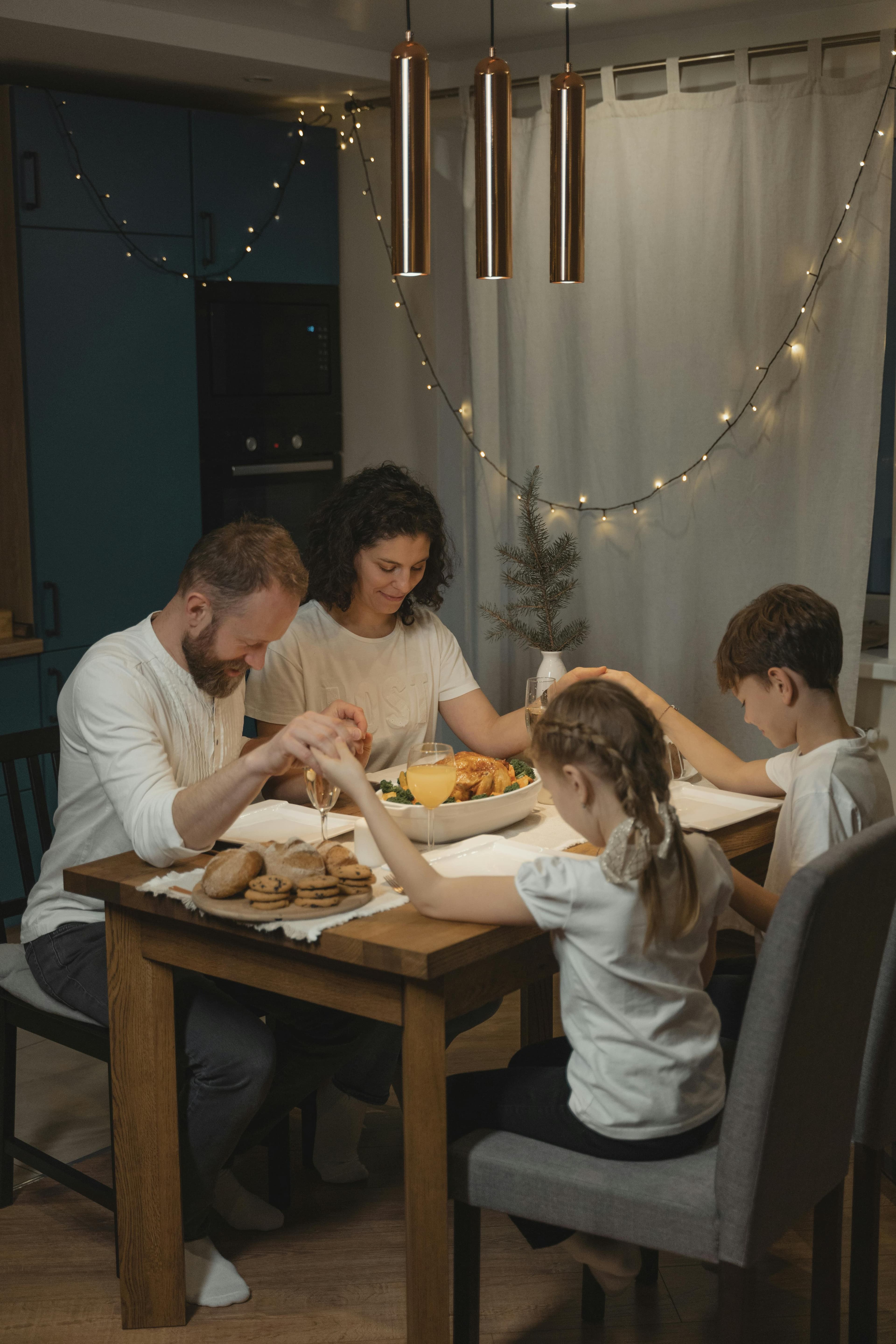 Family holding hands in prayer