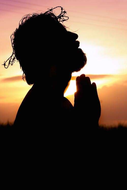 Man in prayer silhouette